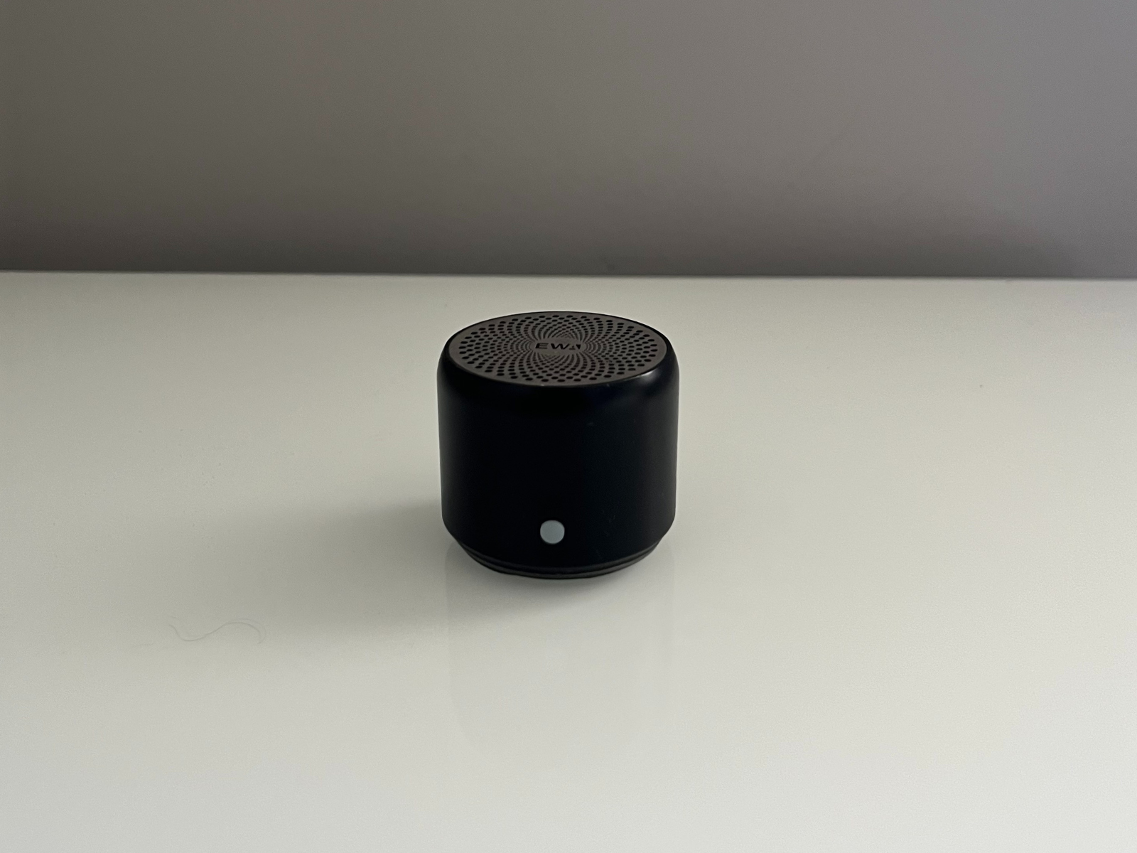 This is the photo I used as reference for my 3D modeling project in Cinema 4D. It shows a small black portable speaker with a round grill on the top and one button in the front. I chose this object because it has a simple but easy-to-recognize design. It helped me practice with basic shapes like cylinders and also try textures to make the detailed top surface.
