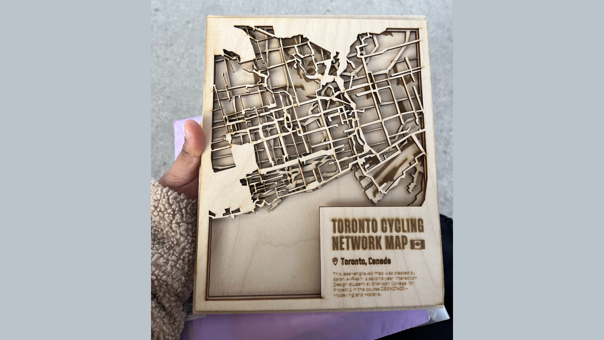 This is a closer angle of the engraving that highlights the burn marks, fine line work, and contrast produced by the laser. It captures how the wood surface reacted to different engraving depths.