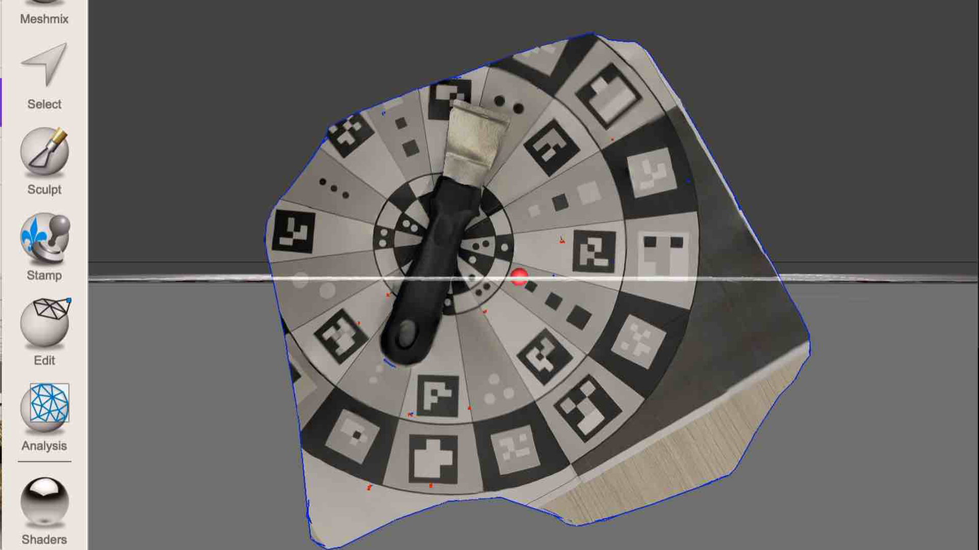 This image shows the scan of the reference marker sheet with a tool placed on top. The edges scanned unevenly, but the calibration pattern is still visible.