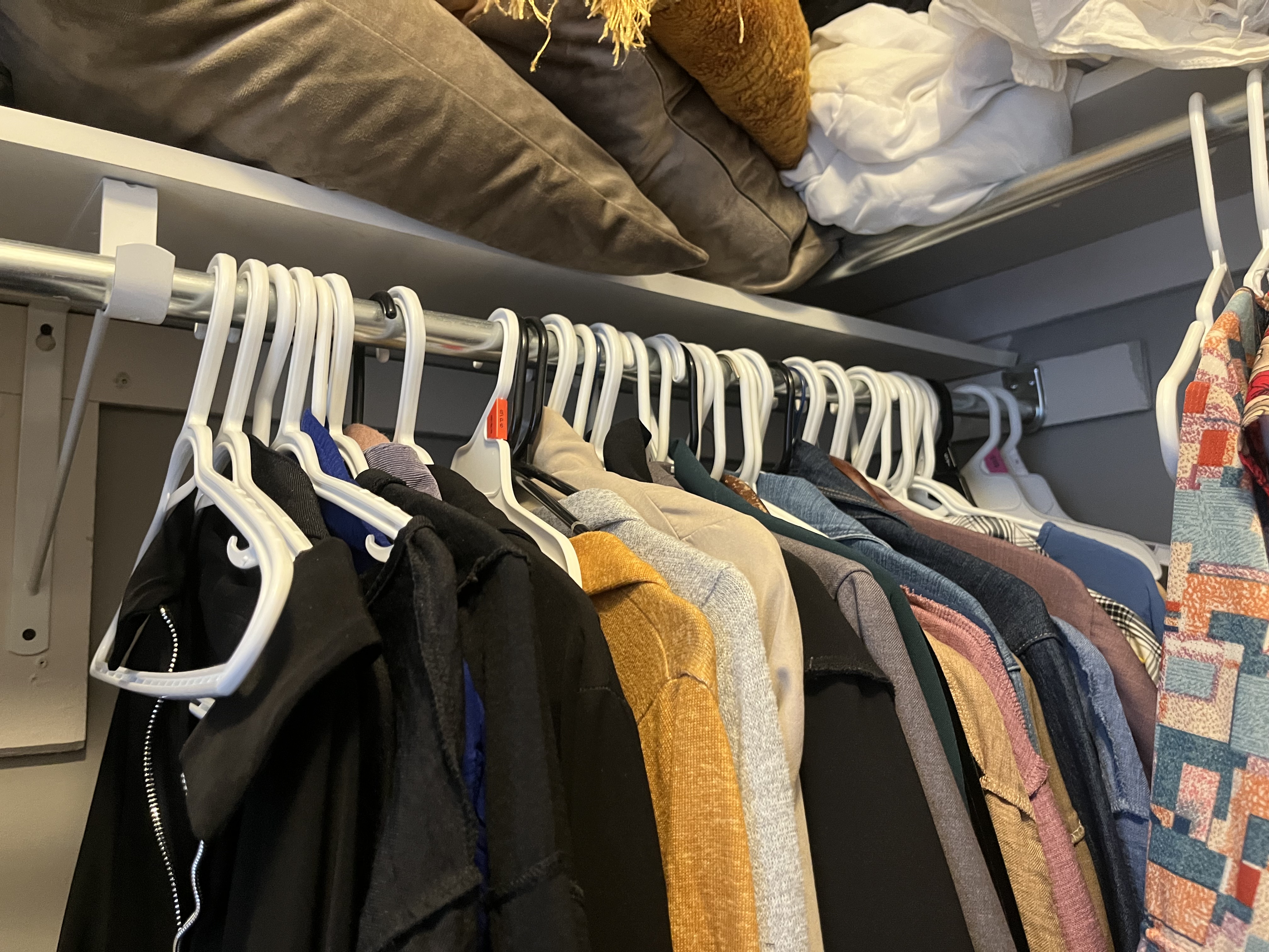 This is the sound of the clothing rack being moved side to side, with the hangers sliding and clacking against the metal rod.