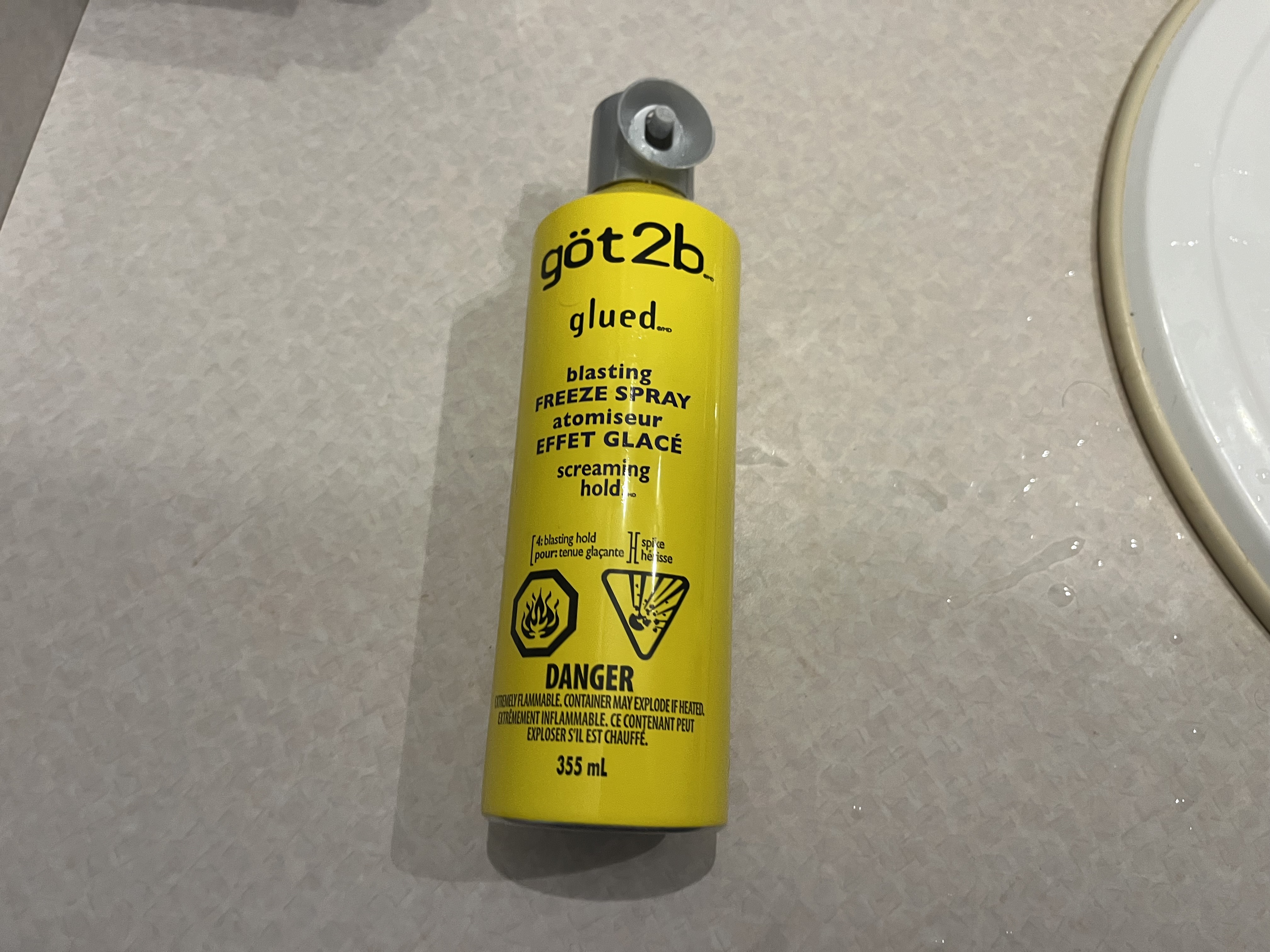 This is the sound of the hairspray nozzle being pressed, with three short sprays applied directly to my hair.